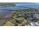 Aerial view features waterfront home with serene bay and easy access to open water at 3484 Shore Dr, Safety Harbor, FL 34695