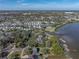 Stunning aerial view showcases waterfront home surrounded by lush greenery and a tranquil bay at 3484 Shore Dr, Safety Harbor, FL 34695