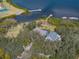 An aerial of a waterfront home features dock access and a lush, green setting at 3484 Shore Dr, Safety Harbor, FL 34695
