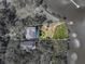 Aerial view of waterfront property with dock and gazebo; surrounding vegetation highlighted by white border at 3484 Shore Dr, Safety Harbor, FL 34695