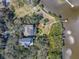 Aerial view of property with pool, dock, landscaping, and bayou access at 3484 Shore Dr, Safety Harbor, FL 34695