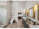 Bathroom featuring a glass-enclosed shower, toilet, and a dual sink vanity with granite countertop at 3484 Shore Dr, Safety Harbor, FL 34695