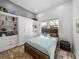 Cozy bedroom with wood-look floors, ensuite bathroom and built-in shelves and cabinets at 3484 Shore Dr, Safety Harbor, FL 34695