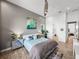 Bedroom with attached bathroom, decor shelves, and light gray walls at 3484 Shore Dr, Safety Harbor, FL 34695