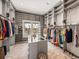 Expansive walk-in closet with custom shelving, hanging rods, center island and ladder at 3484 Shore Dr, Safety Harbor, FL 34695