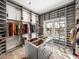 Spacious walk-in closet with center island, custom storage, and natural light from window at 3484 Shore Dr, Safety Harbor, FL 34695