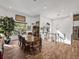 Bright dining room with wood-look tile flooring, natural light, and staircase access at 3484 Shore Dr, Safety Harbor, FL 34695