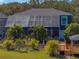 Aerial view of house exterior with screened-in pool, gazebo, bridge, mature trees, and landscaping at 3484 Shore Dr, Safety Harbor, FL 34695