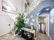 Elegant foyer featuring stylish decor, tile flooring, a glass railing staircase, and a calming blue wall at 3484 Shore Dr, Safety Harbor, FL 34695