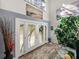 Bright and inviting foyer with beautiful double doors, wood-look tile flooring, and high ceilings at 3484 Shore Dr, Safety Harbor, FL 34695