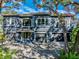 Beautiful two-story home with a three-car garage, mature trees, and a well-manicured front yard at 3484 Shore Dr, Safety Harbor, FL 34695