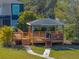 Custom gazebo with a walkway and lush landscaping in a well-maintained backyard at 3484 Shore Dr, Safety Harbor, FL 34695