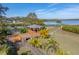Tranquil backyard featuring a wooden gazebo, walkway, and view of the waterfront at 3484 Shore Dr, Safety Harbor, FL 34695