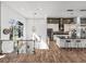Modern, open-concept kitchen with stainless steel appliances, island seating, and seamless access from the staircase at 3484 Shore Dr, Safety Harbor, FL 34695