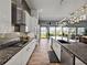 Bright open kitchen features granite countertops, stainless appliances, and access to dining and living areas at 3484 Shore Dr, Safety Harbor, FL 34695