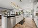Modern kitchen boasts a large island, stainless appliances, and wood-look tile flooring at 3484 Shore Dr, Safety Harbor, FL 34695
