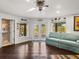 Living room features a seating area, hardwood floors, and outside patio access at 3484 Shore Dr, Safety Harbor, FL 34695