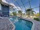 Beautiful screened pool with an attached spa and brick paver surround at 3484 Shore Dr, Safety Harbor, FL 34695