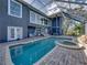 Stunning screened pool area featuring a spa and plenty of space for outdoor entertaining at 3484 Shore Dr, Safety Harbor, FL 34695