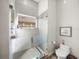 Glass enclosed shower with a built-in bench and sleek chrome fixtures at 3484 Shore Dr, Safety Harbor, FL 34695