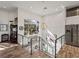Bright, open staircase with glass railings and a stunning chandelier, open to kitchen at 3484 Shore Dr, Safety Harbor, FL 34695