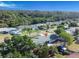 A charming single-story home nestled among mature trees and lush greenery with a view of the water in the background at 352 79Th Ne Ave, St Petersburg, FL 33702