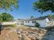 A spacious backyard featuring a well-manicured lawn, mature trees, and a private patio area, perfect for outdoor relaxation at 352 79Th Ne Ave, St Petersburg, FL 33702