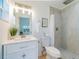 Bathroom with sleek vanity and tiled shower, a modern and stylish space designed for comfort at 352 79Th Ne Ave, St Petersburg, FL 33702