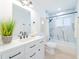 Modern bathroom with marble tile, new vanity, and tub/shower combo offering a sleek and stylish design at 352 79Th Ne Ave, St Petersburg, FL 33702