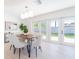 Bright dining room featuring a modern chandelier, seating for six, and French doors to the outdoor area at 352 79Th Ne Ave, St Petersburg, FL 33702