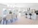 Modern dining area with a contemporary light fixture, kitchen island seating, and new stainless steel appliances at 352 79Th Ne Ave, St Petersburg, FL 33702