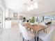 Dining area adjacent to a modern kitchen with an open layout, contemporary light fixture, and stylish decor at 352 79Th Ne Ave, St Petersburg, FL 33702