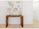 An entryway featuring a wooden console table with decor and a modern art piece at 352 79Th Ne Ave, St Petersburg, FL 33702