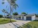 Inviting single-story home with a freshly painted exterior, attached garage, and a well-maintained front lawn at 352 79Th Ne Ave, St Petersburg, FL 33702