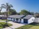 Aerial view of a newly renovated single-story home with a pristine lawn, modern roof, and an attached garage at 352 79Th Ne Ave, St Petersburg, FL 33702