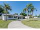 Street view of a freshly renovated single-story home with mature palm trees and a modern front entrance at 352 79Th Ne Ave, St Petersburg, FL 33702