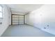 A clean and well-lit attached garage featuring a freshly painted floor and an access door to the main residence at 352 79Th Ne Ave, St Petersburg, FL 33702