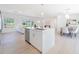 Open kitchen with stainless steel appliances, a large island, and a dining area with view at 352 79Th Ne Ave, St Petersburg, FL 33702