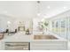 Open-concept kitchen with island sink, stainless steel appliances and adjacent dining area at 352 79Th Ne Ave, St Petersburg, FL 33702