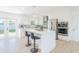 Modern kitchen with white cabinets, stainless steel appliances, and a large center island at 352 79Th Ne Ave, St Petersburg, FL 33702