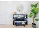Living room featuring a black shelving unit, a round mirror, and a potted plant at 352 79Th Ne Ave, St Petersburg, FL 33702