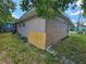 Back exterior of home showing brick and stucco, siding and an open yard at 3714 E Ellicott St, Tampa, FL 33610