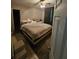 Bedroom with a ceiling fan, carpeting, and neutral walls with a comfortable bed at 3714 E Ellicott St, Tampa, FL 33610