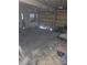 Spacious garage interior with an open garage door, concrete flooring and room for storage at 3714 E Ellicott St, Tampa, FL 33610