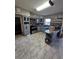 Spacious kitchen featuring gray cabinetry, tiled floor, mosaic backsplash, and a breakfast bar for casual dining at 3714 E Ellicott St, Tampa, FL 33610