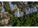 Overhead view of townhome surrounded by trees, highlighting its location within a neighborhood at 39650 Us Highway 19 N # 743, Tarpon Springs, FL 34689