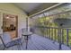 View of a screened-in balcony with outdoor seating overlooking trees and sky at 39650 Us Highway 19 N # 743, Tarpon Springs, FL 34689