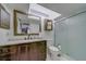 Bathroom featuring a vanity with dark cabinets, a large mirror, and a glass-enclosed shower stall at 39650 Us Highway 19 N # 743, Tarpon Springs, FL 34689