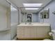 Bright bathroom featuring a large vanity mirror, updated fixtures, and a glass-enclosed shower at 39650 Us Highway 19 N # 743, Tarpon Springs, FL 34689