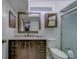Bathroom featuring a vanity with dark cabinets, a large mirror, and a glass-enclosed shower stall at 39650 Us Highway 19 N # 743, Tarpon Springs, FL 34689